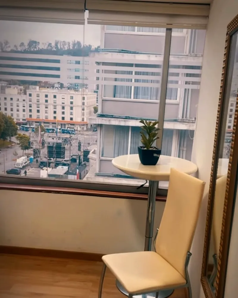 Rincón del box con silla y mesa junto a la ventana